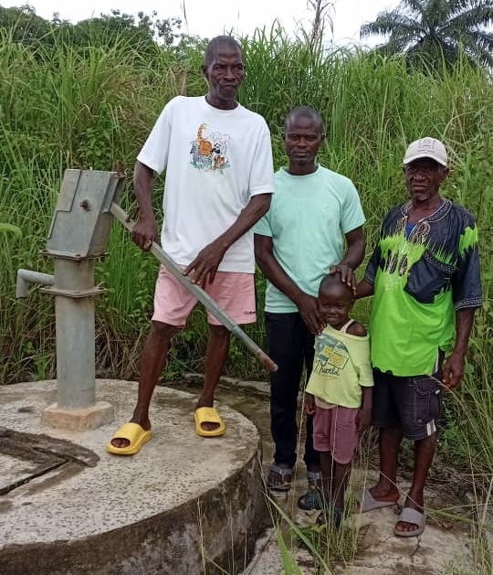 Tamba Nyuma, right, poses with his family. Photo Credit: Augustine Tamba Thomas/Engage Salone.
